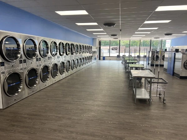 Clean stainless steel stacked dryers and folding tables